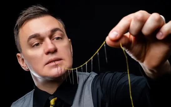 magician swallows sewing needles